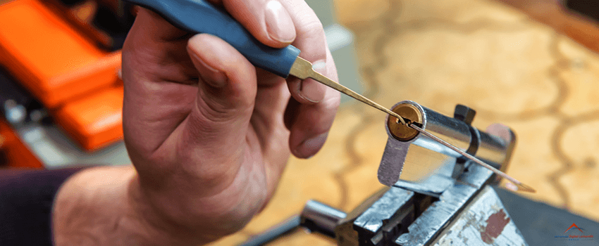 Locksmith repairs the door lock cylinder.