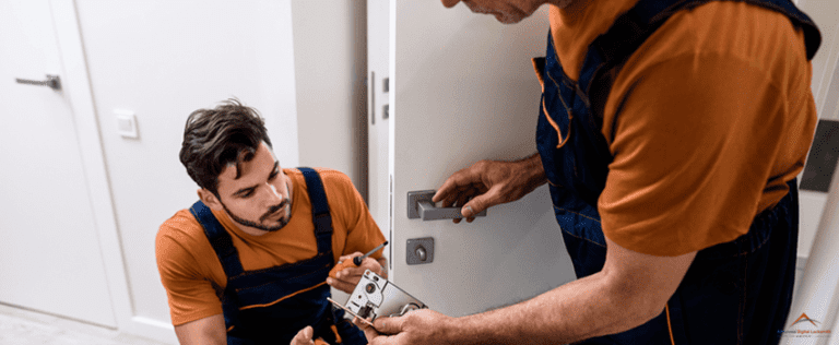 ADLG-Two locksmith, repairmen, workers in uniform installing, working with house door lock using screwdriver