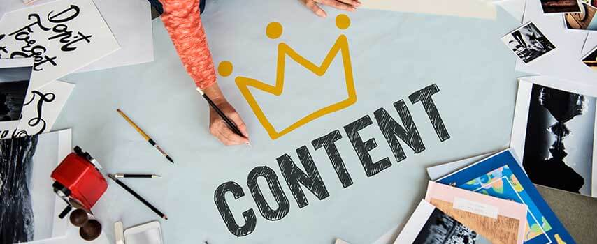 Woman Drawing the word content with a yellow crown on top.